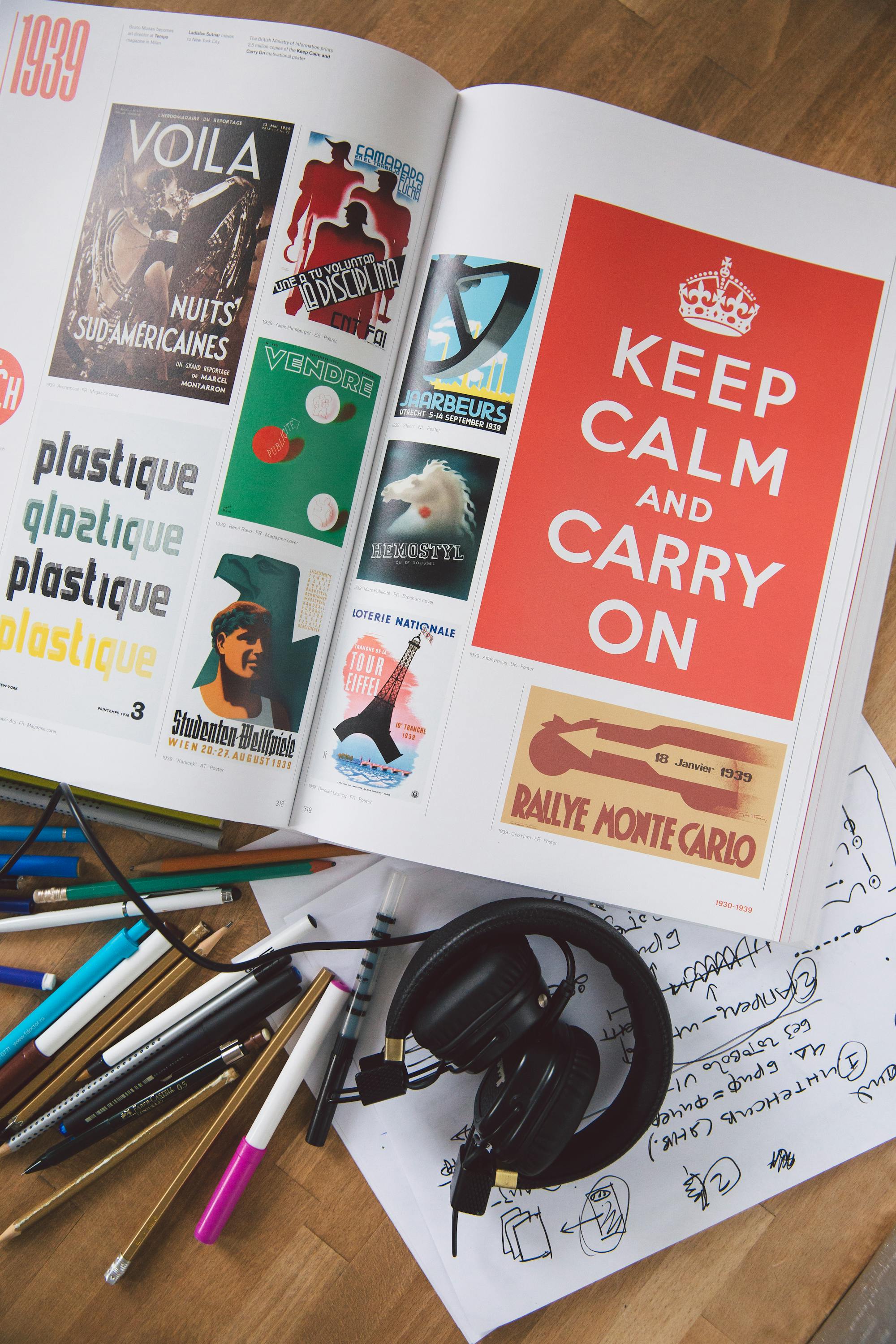 Open editorial magazine on a designer's desk