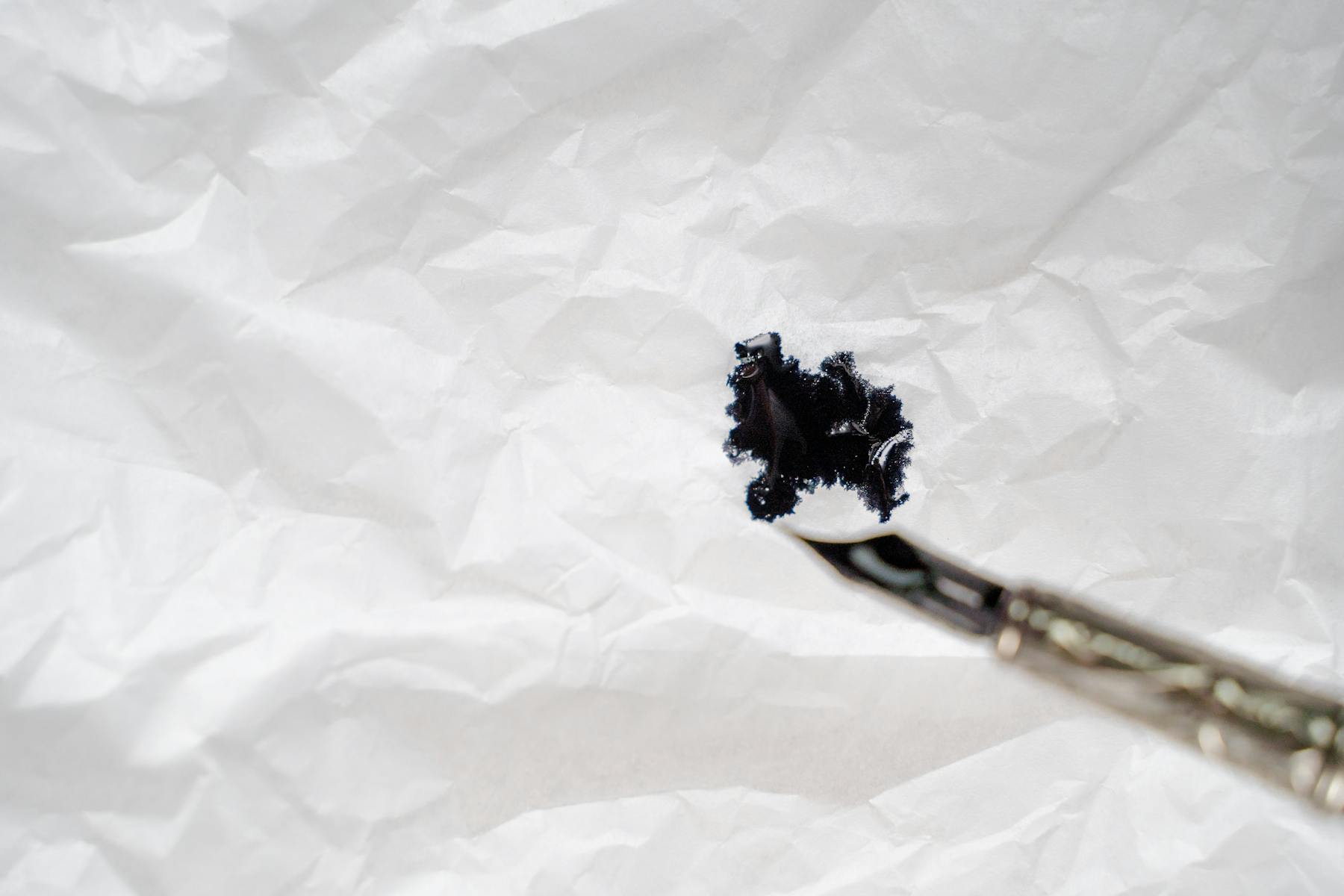 Black ink splash on paper